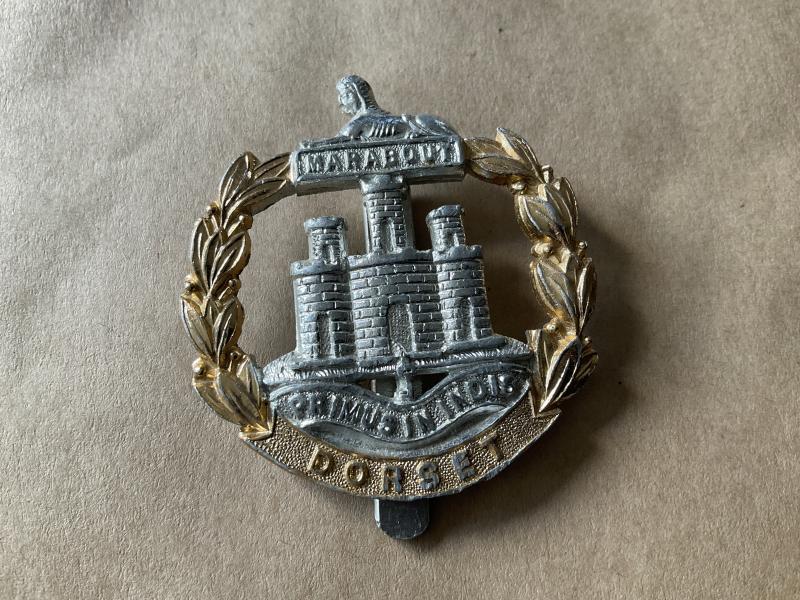 Anodised Dorset Regiment cap badge.