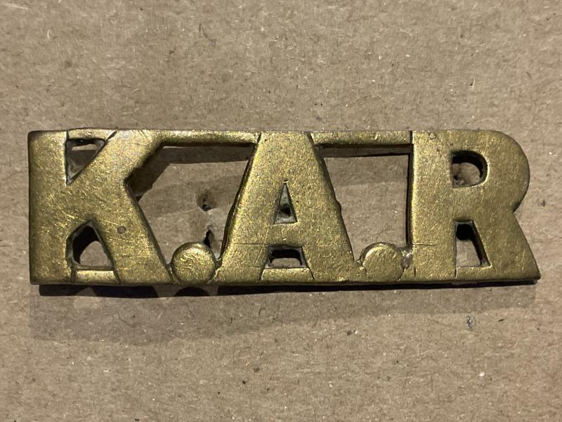 K.A.R (Kings African Rifles) brass shoulder title.